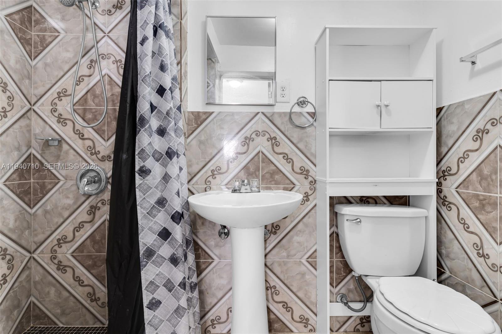 20900 Southwest 118th Avenue Miami, FL 33177 - Photo 25 of 41 a bathroom with a toilet sink and mirror