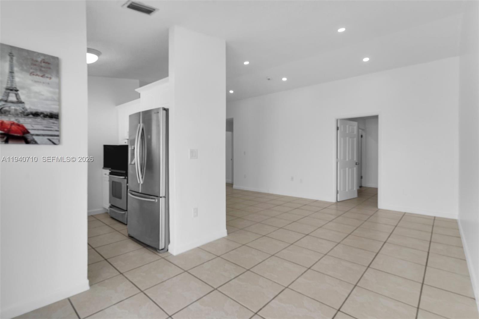 20900 Southwest 118th Avenue Miami, FL 33177 - Photo 7 of 41 a view of a refrigerator in kitchen and an empty room