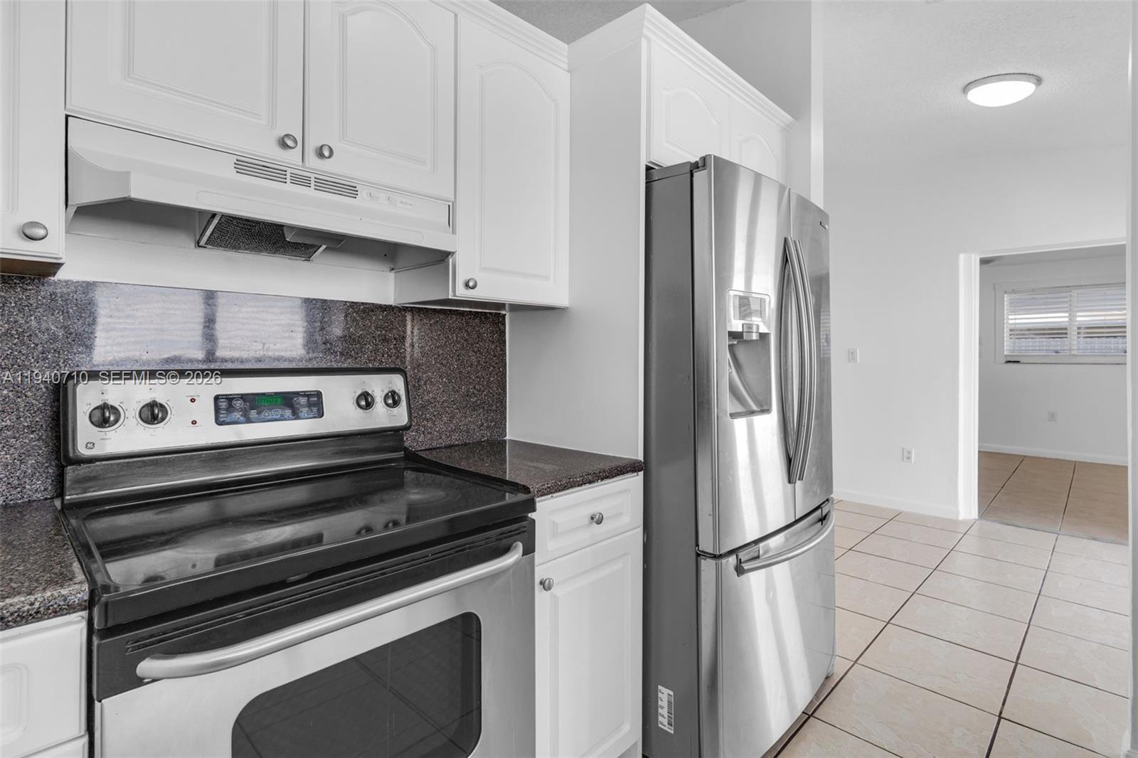 20900 Southwest 118th Avenue Miami, FL 33177 - Photo 9 of 41 a view of kitchen with refrigerator and cabinets