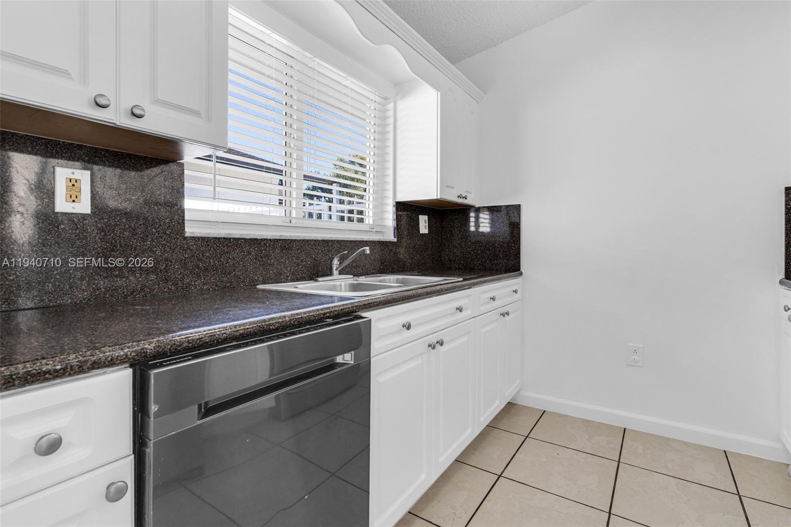 20900 Southwest 118th Avenue Miami, FL 33177 - Photo 10 of 41 a kitchen with stainless steel appliances granite countertop a sink stove and microwave