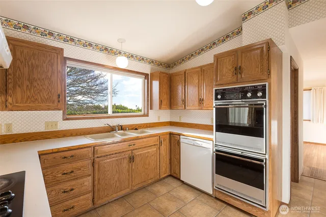 a kitchen with granite countertop cabinets stainless steel appliances and window
