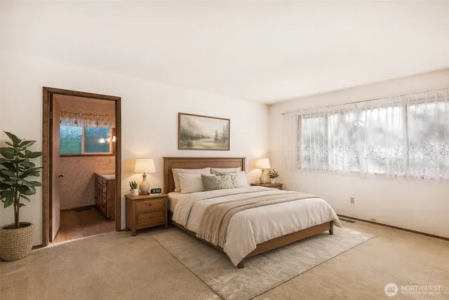 a bedroom with a bed and a large window