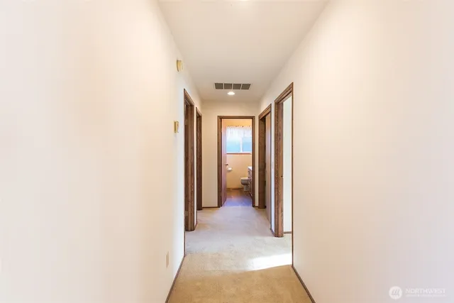 a bathroom with a sink a toilet a mirror and vanity