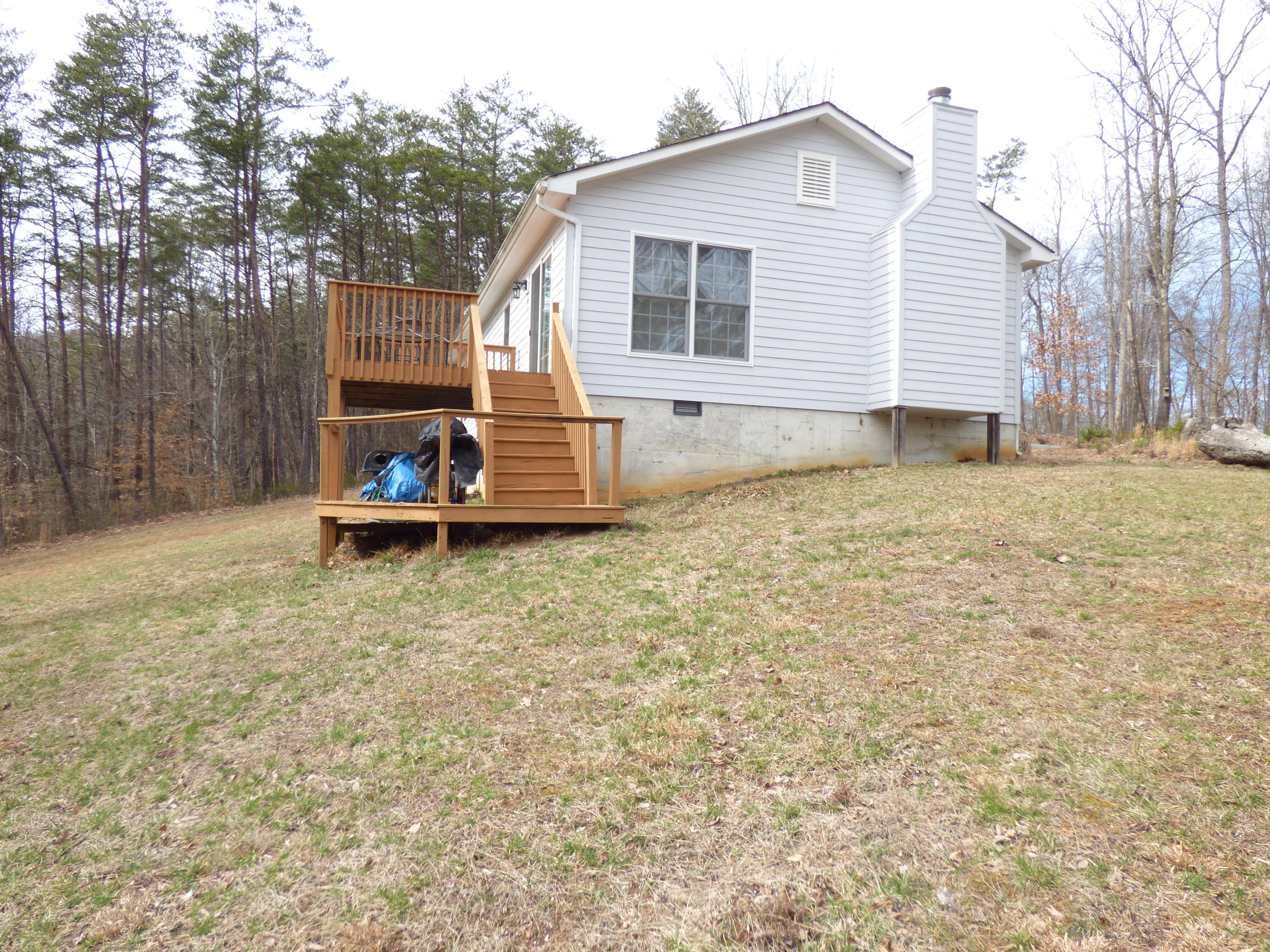 435 Endicott Hill Road Ferrum, VA 24088 - Photo 2 of 22 a backyard of a house with table and chairs