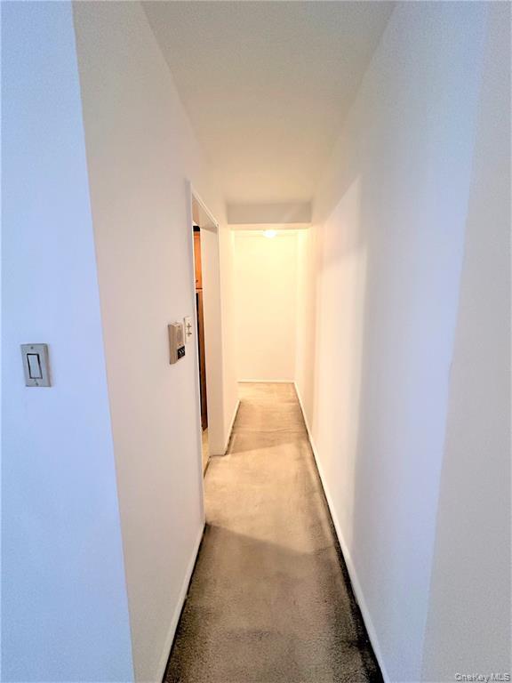 99-06 58th Avenue, Unit 3H Queens, NY 11368 - Photo 14 of 23 a view of a hallway with white walls