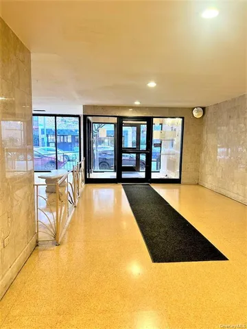 a view of a lobby with furniture and floor to ceiling window