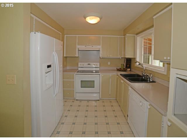 3504 E Street Springfield, OR 97478 - Photo 6 of 16 a kitchen with a sink a stove and refrigerator