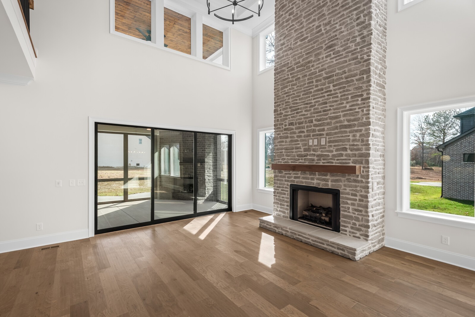 7221 Severide Street Fairview, TN 37062 - Photo 15 of 59 a view of an empty room with wooden floor fireplace and a window