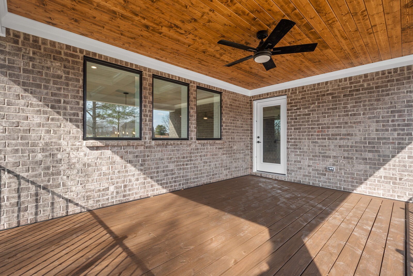 7221 Severide Street Fairview, TN 37062 - Photo 43 of 59 a view of a porch with wooden floor and a ceiling fan