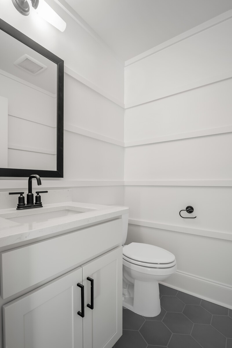 7221 Severide Street Fairview, TN 37062 - Photo 44 of 59 a bathroom with a toilet a sink and mirror