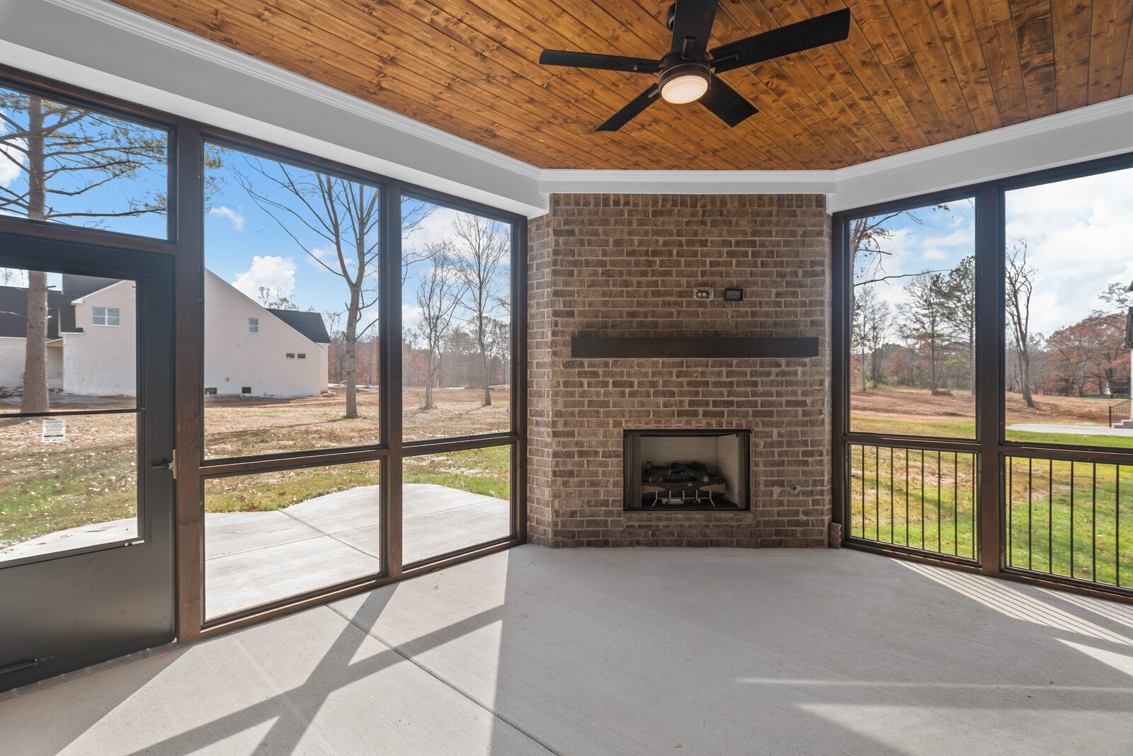 7221 Severide Street Fairview, TN 37062 - Photo 55 of 59 a living room with a fireplace and a floor to ceiling window