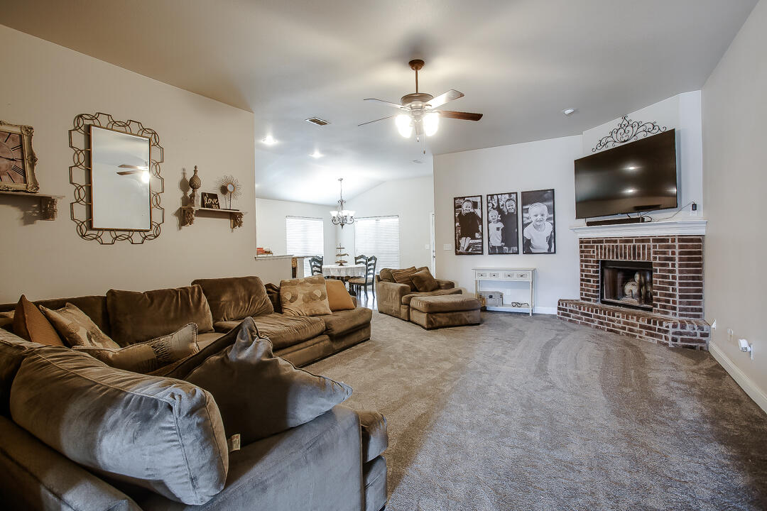 8804 Rochester Avenue Lubbock, TX 79424 - Photo 3 of 18 a living room with furniture and a flat screen tv