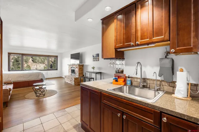 a kitchen with sink a stove and cabinets