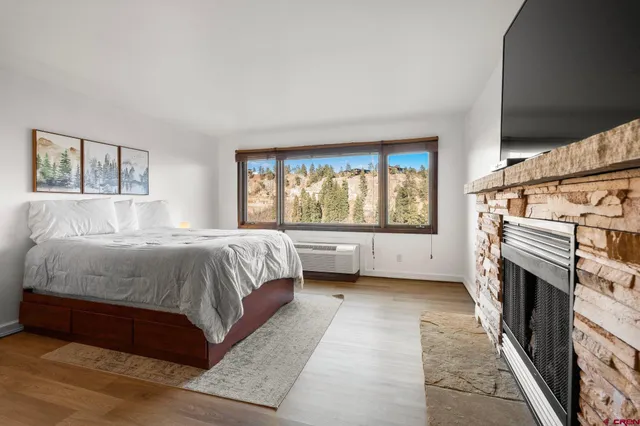 a bedroom with a bed and a fireplace