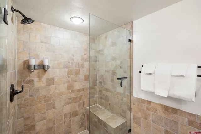 a bathroom with a shower and a sink