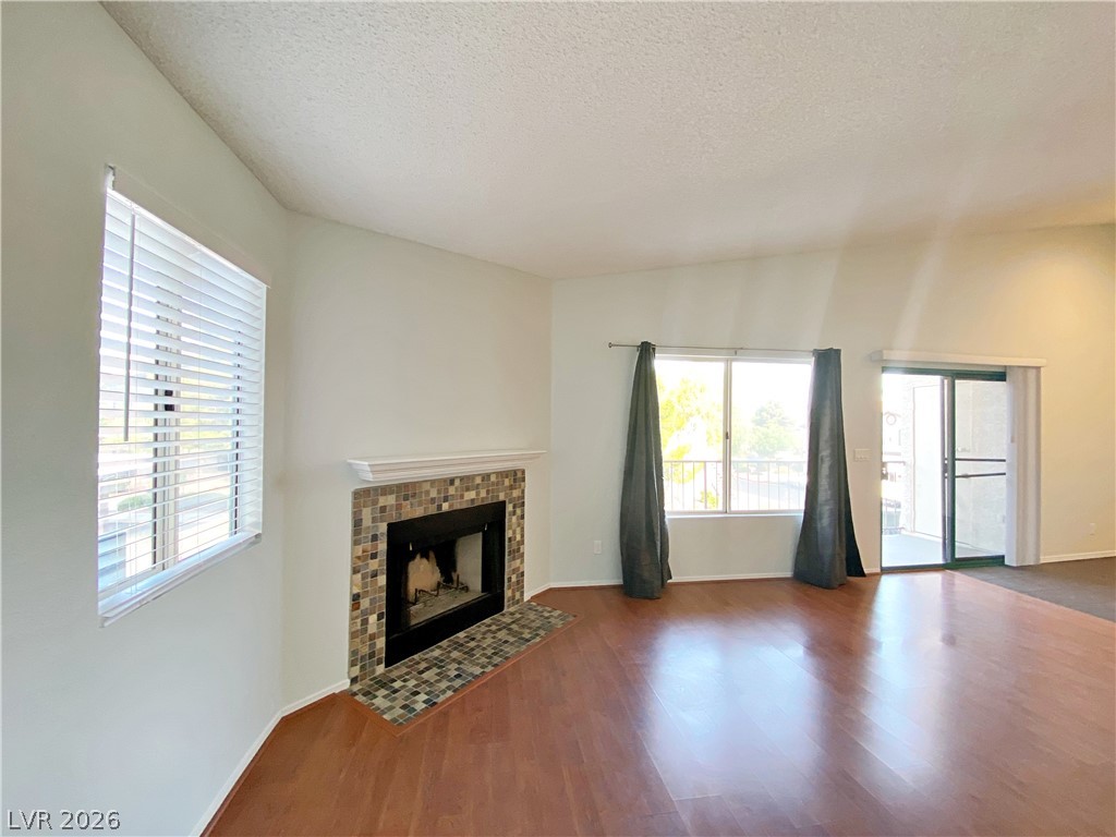 1575 West Warm Springs Road, Unit 1024 Henderson, NV 89014 - Photo 3 of 25 A striking fireplace with a tiled hearth anchors this generously proportioned living space.