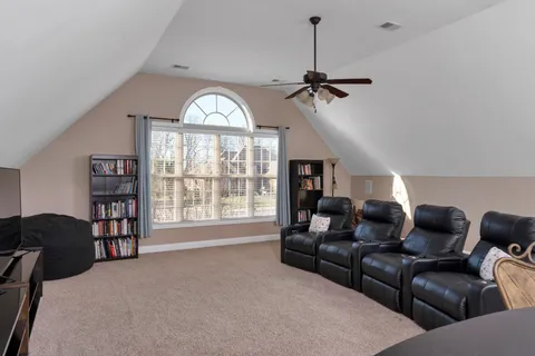 a living room with furniture a chandelier and a large window