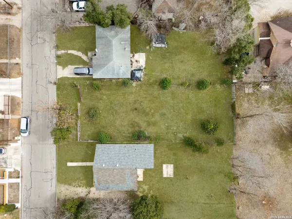 an aerial view of a houses with yard