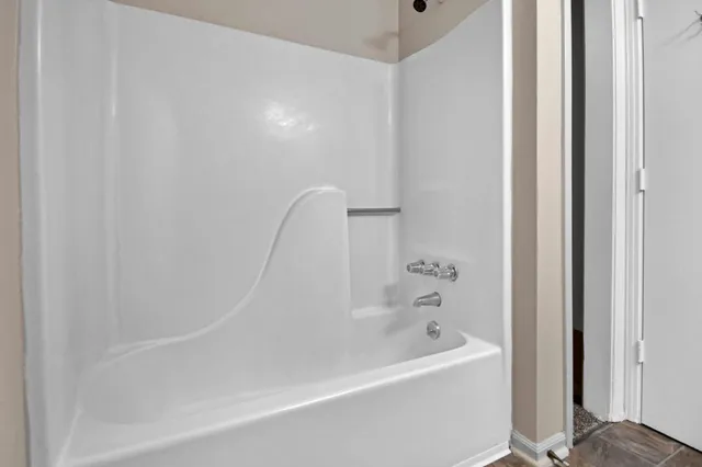 a white bath tub sitting next to a white sink