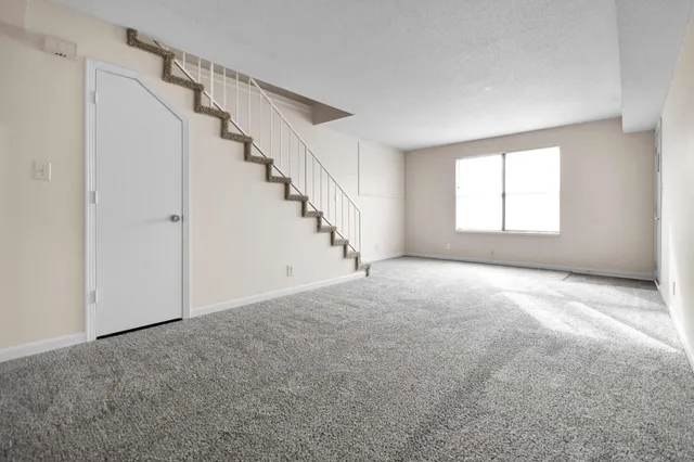 a view of empty room with stairs
