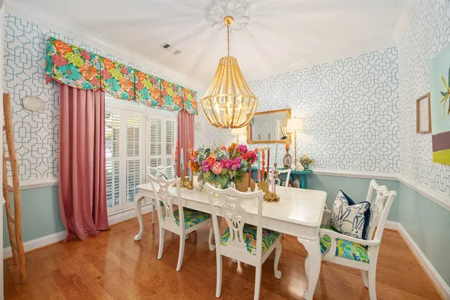 a living room with furniture a fireplace and a chandelier