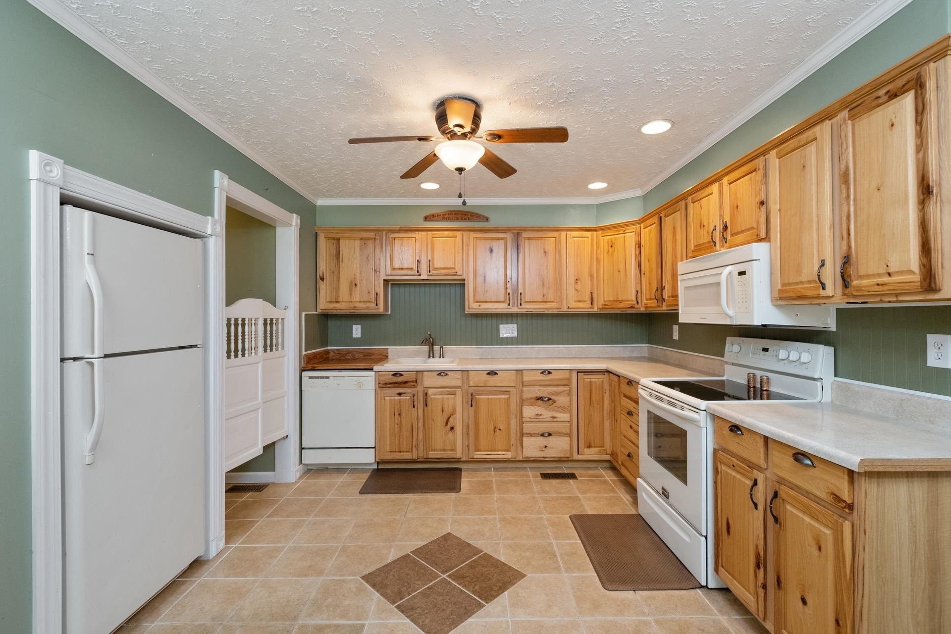 1845 Mt Torrey Road Lyndhurst, VA 22952 - Photo 3 of 27 a kitchen with stainless steel appliances granite countertop a refrigerator a sink dishwasher a stove with wooden cabinets and floor