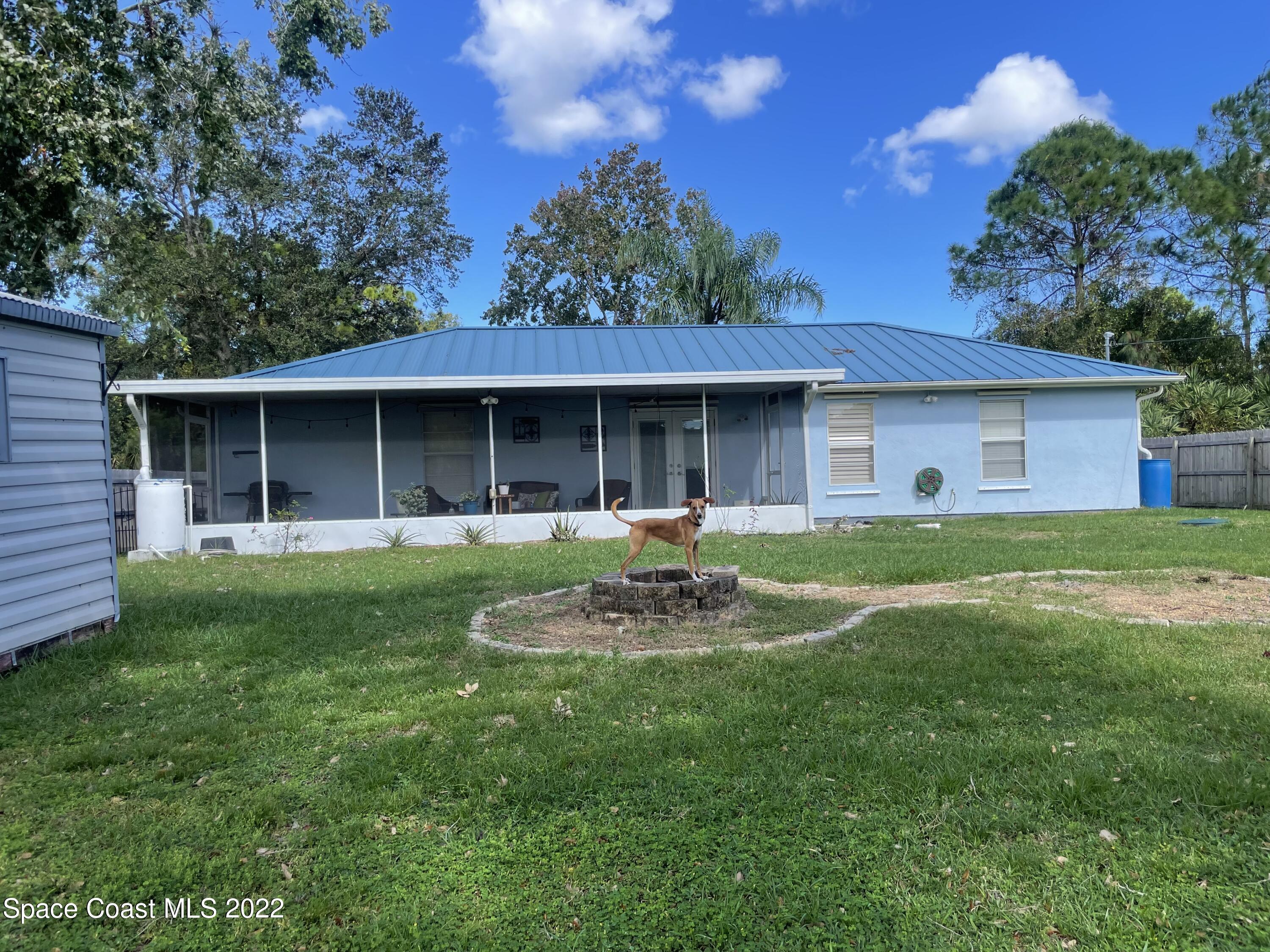 258 San Remo Road Southwest Palm Bay, FL 32908 - Photo 2 of 6 a front view of a house with a garden