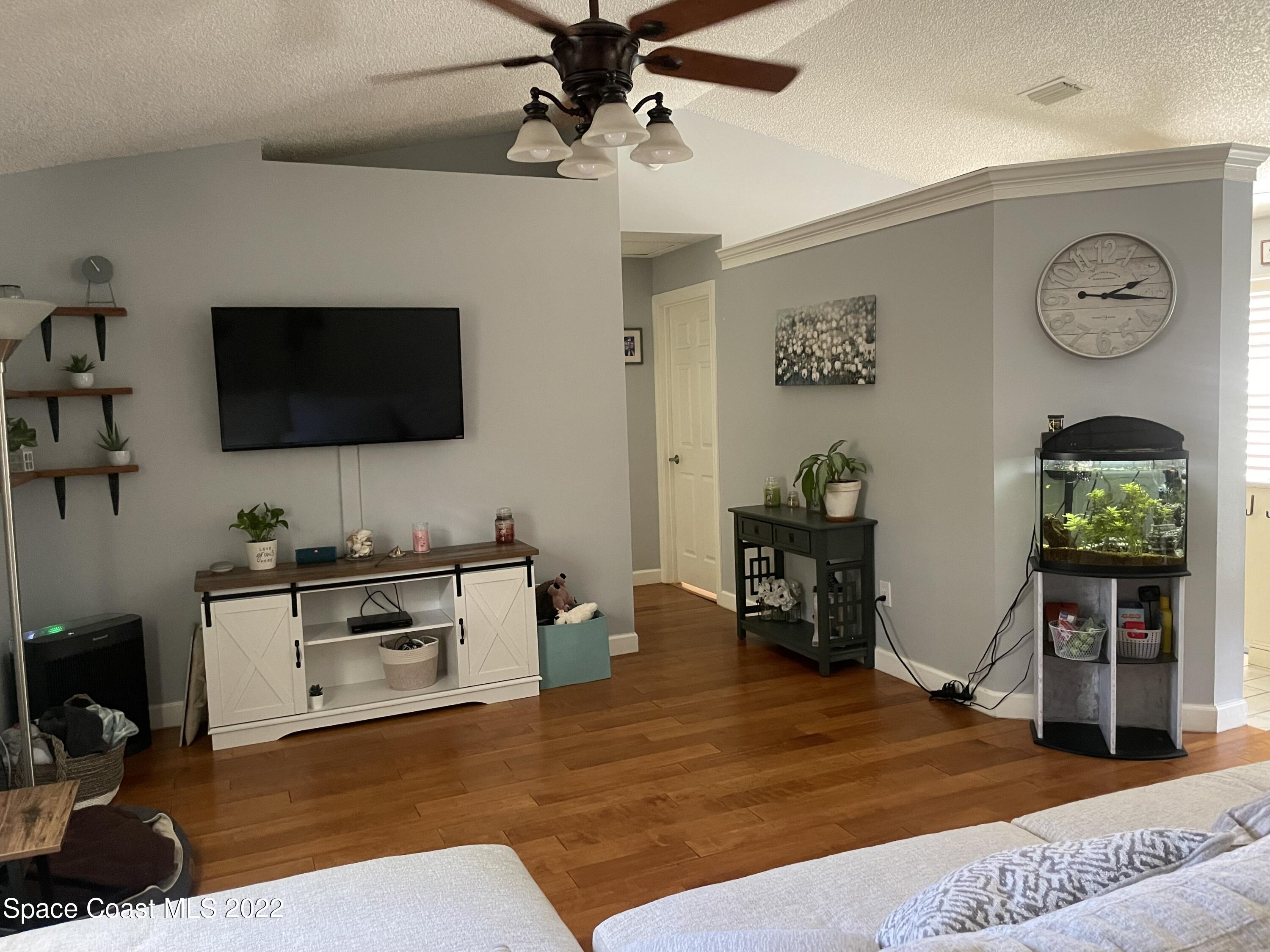 258 San Remo Road Southwest Palm Bay, FL 32908 - Photo 5 of 6 a living room with furniture and a flat screen tv