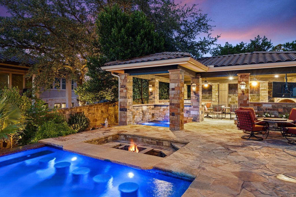 109 Largo Cove Austin, TX 78734 - Photo 32 of 40 An inviting pool area with built-in fire pit, perfect for evening entertainment.