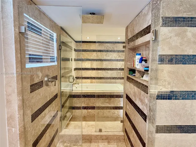 a view of washer and dryer with kitchen in the background