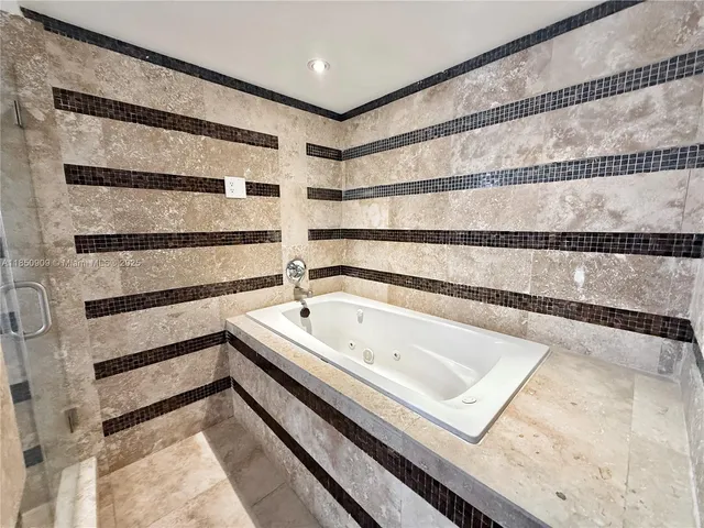 a bathroom with a bathtub and shower