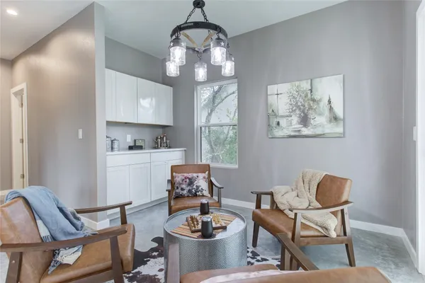 a spacious bedroom with a bed a ceiling fan and a fireplace