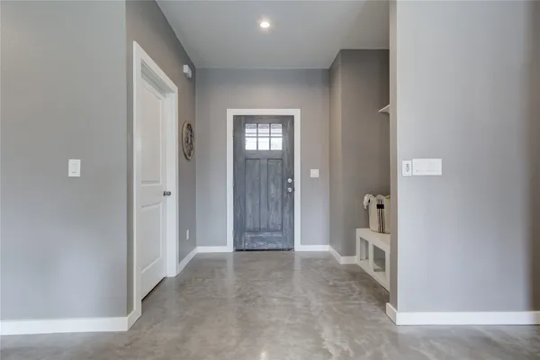 a living room with furniture and a view of kitchen