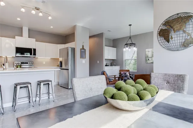 a kitchen with stainless steel appliances a refrigerator stove and sink