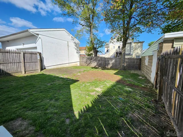 a view of a backyard with a tree