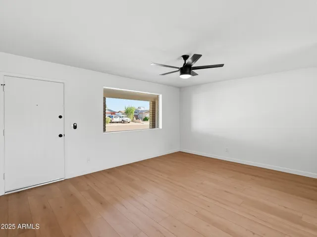 wooden floor in an empty room with a window