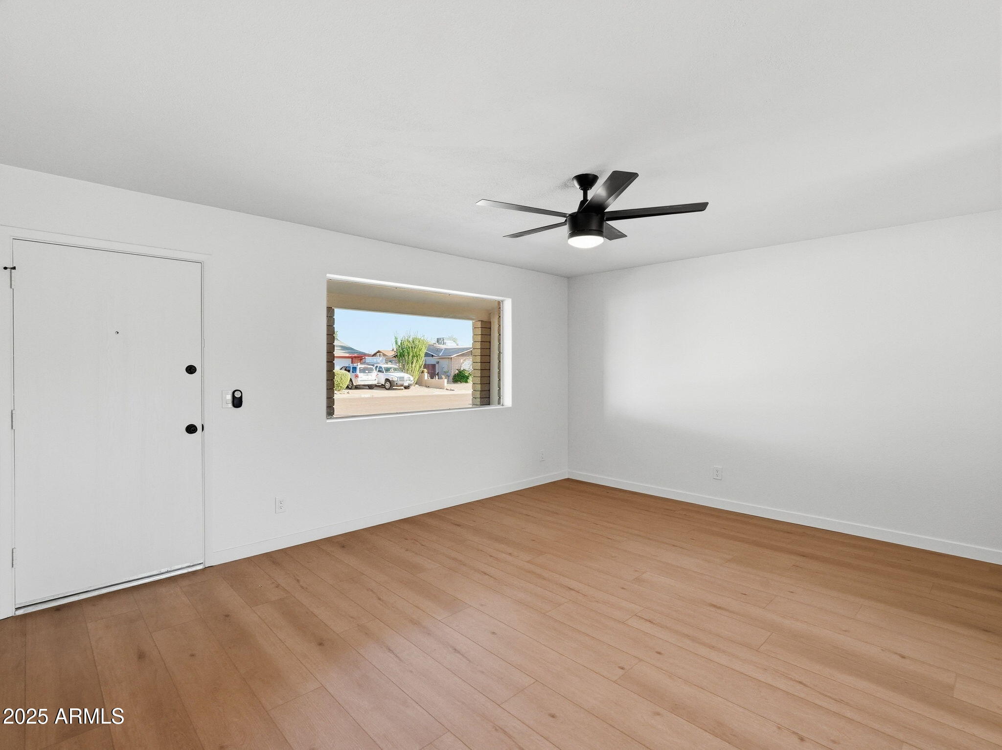 1428 South Palo Verde Drive Apache Junction, AZ 85120 - Photo 15 of 37 wooden floor in an empty room with a window