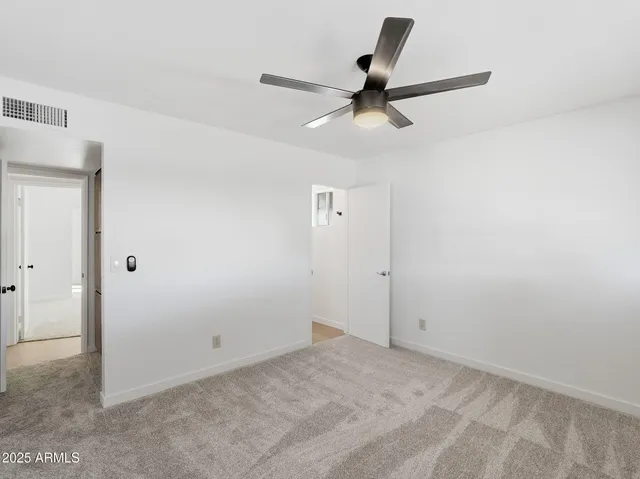 a view of a room with a ceiling fan