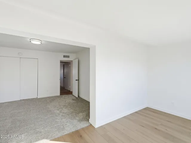 a view of an empty room and wooden floor