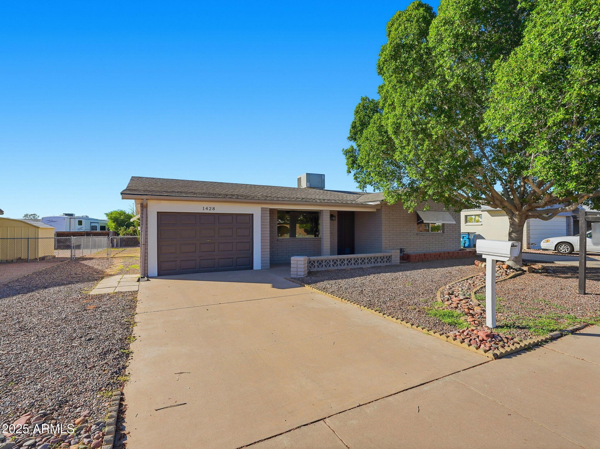 1428 South Palo Verde Drive Apache Junction, AZ 85120 - Photo 2 of 37 a front view of a house with a yard and garage