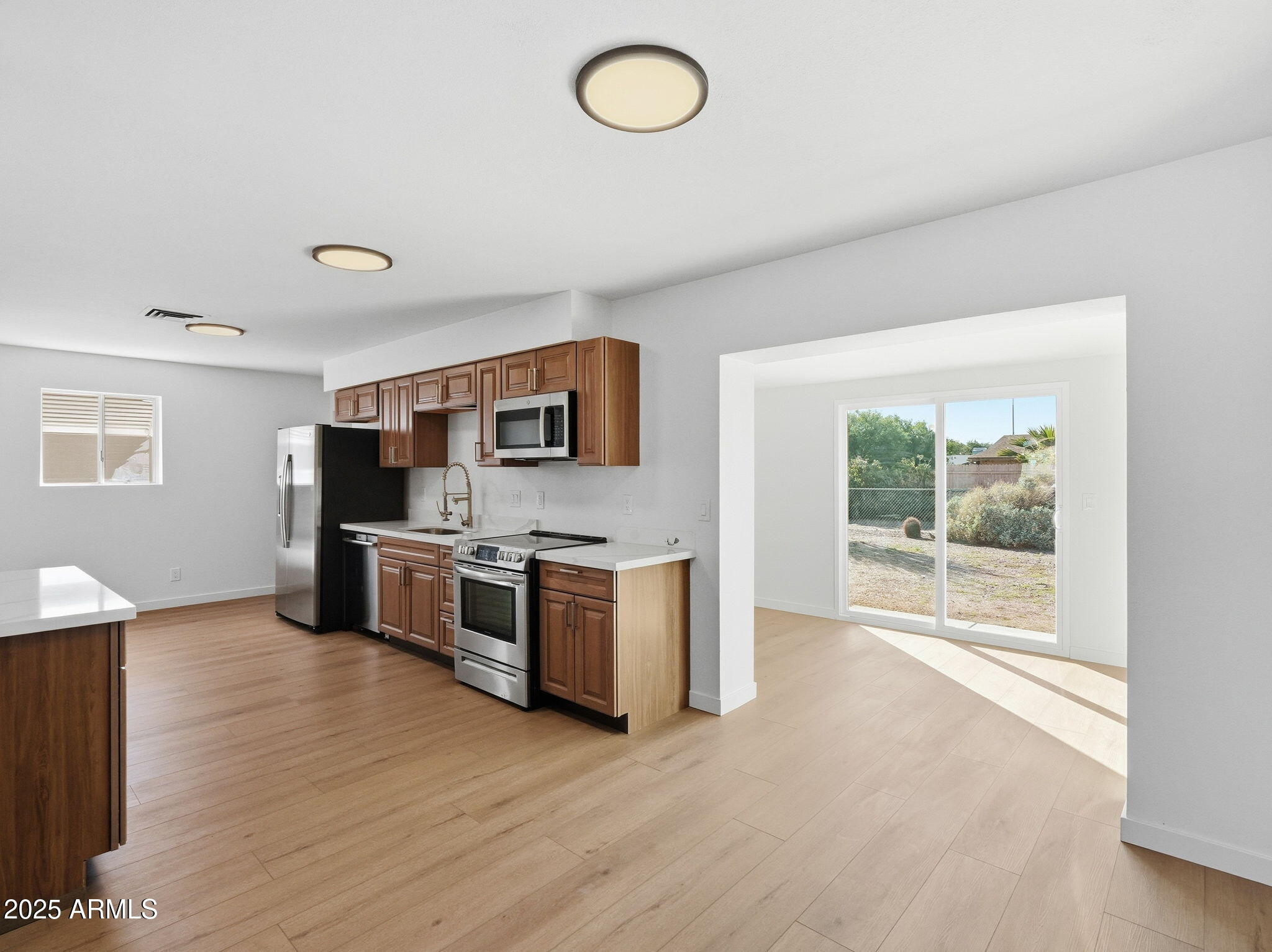 1428 South Palo Verde Drive Apache Junction, AZ 85120 - Photo 4 of 37 a large kitchen with stainless steel appliances granite countertop a stove a sink and a microwave