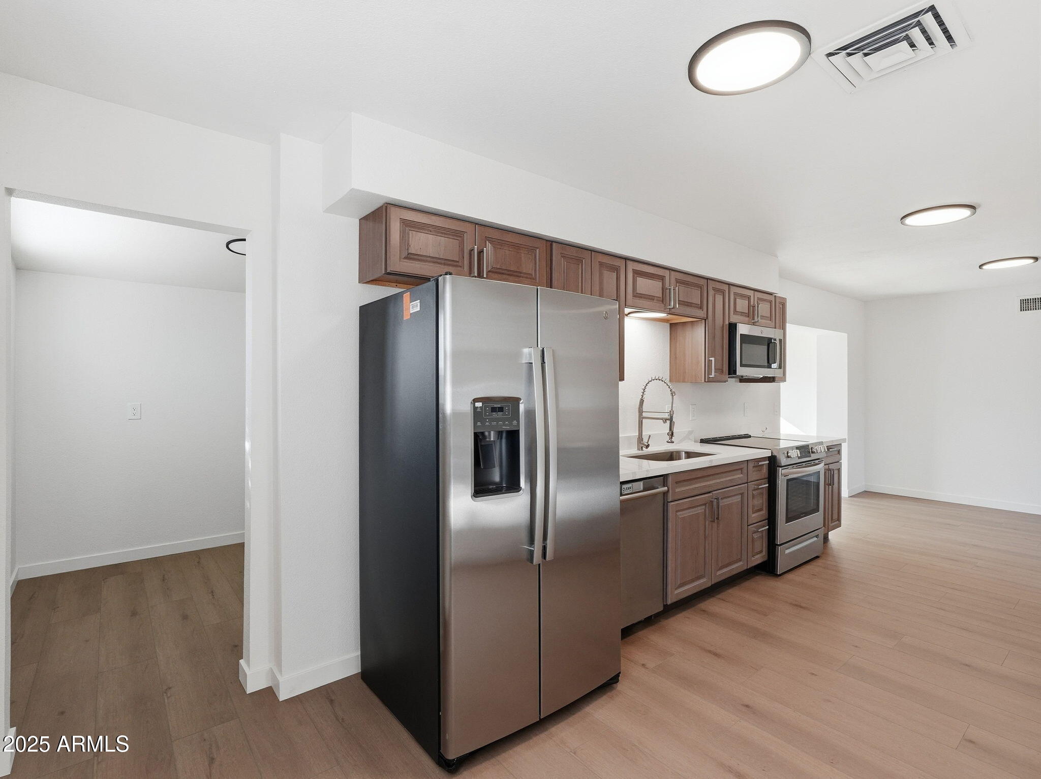 1428 South Palo Verde Drive Apache Junction, AZ 85120 - Photo 8 of 37 a modern kitchen with stainless steel appliances granite countertop a refrigerator and a sink