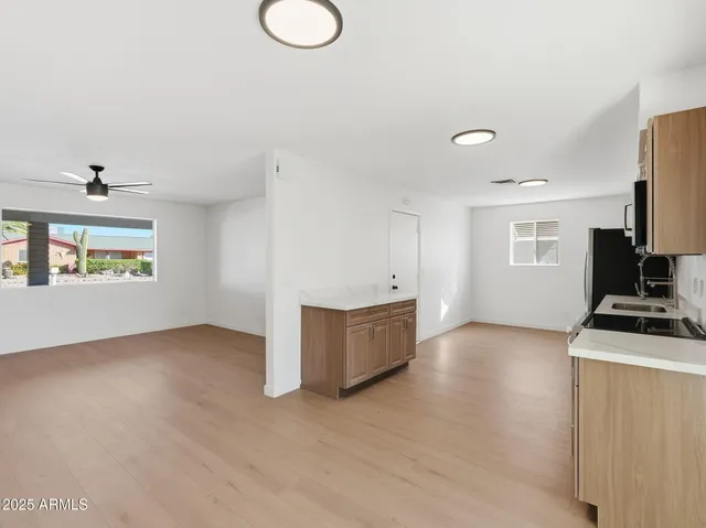 a kitchen with a stove cabinets and wooden floor