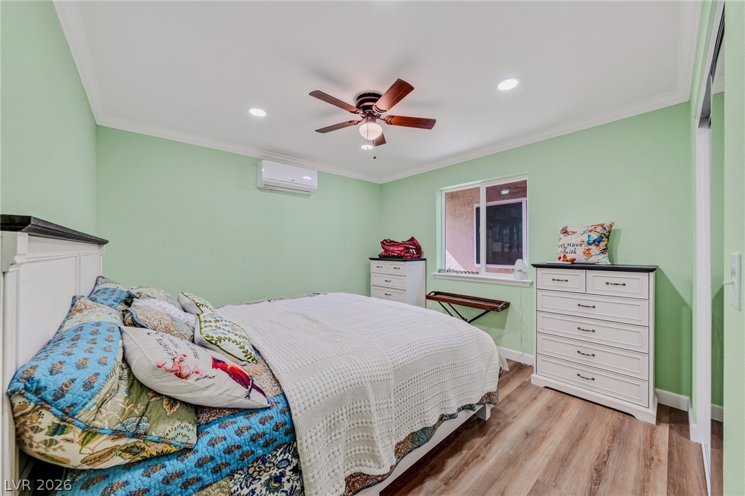 3780 South Ranger Way Pahrump, NV 89048 - Photo 30 of 57 Relax in a comfortable bedroom featuring elegant crown molding and rich hardwood flooring.
