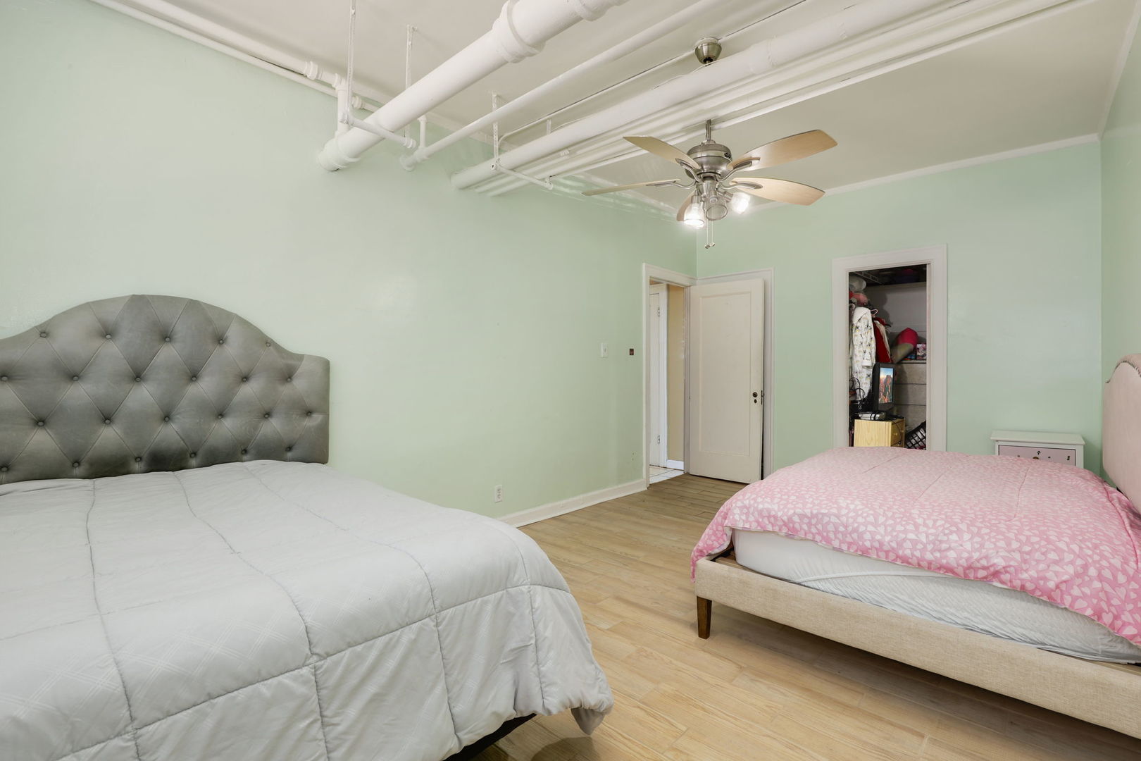 1360 East Madison Park, Unit B Chicago, IL 60615 - Photo 17 of 25 a bedroom with a bed and a chandelier