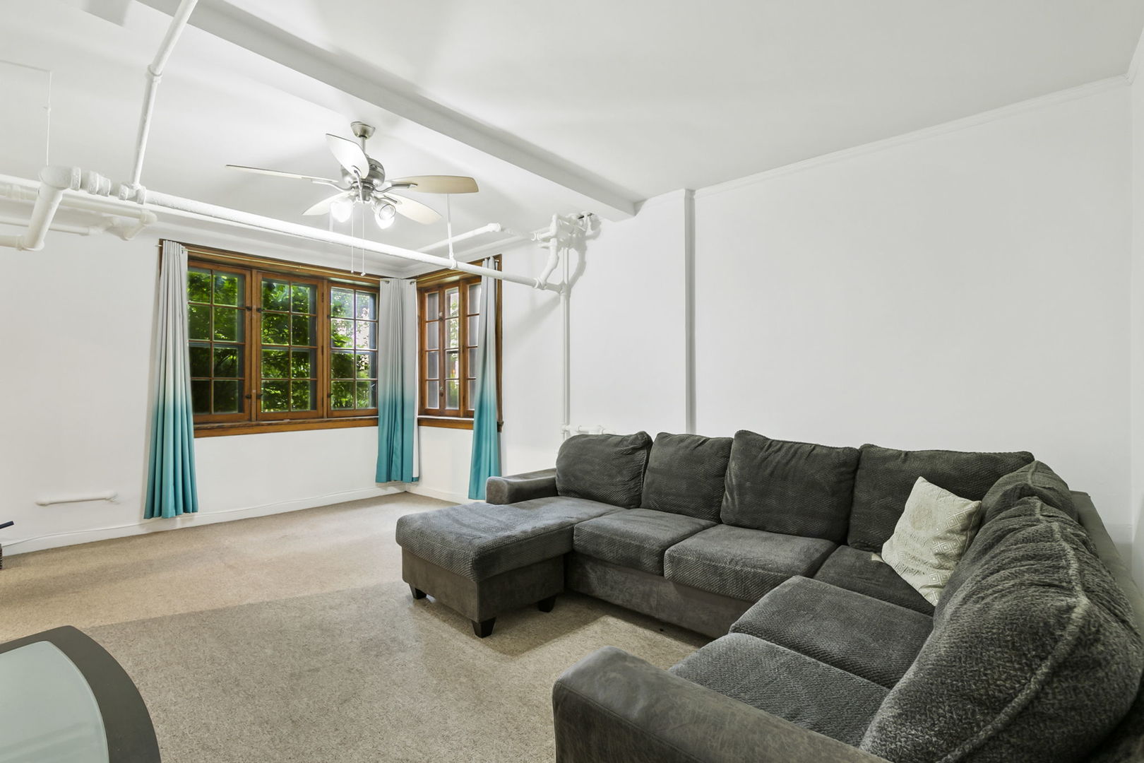 1360 East Madison Park, Unit B Chicago, IL 60615 - Photo 4 of 25 a living room with furniture and a large window