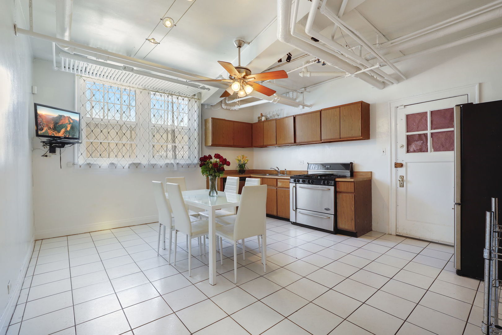 1360 East Madison Park, Unit B Chicago, IL 60615 - Photo 8 of 25 a kitchen with stainless steel appliances granite countertop a refrigerator and a stove top oven