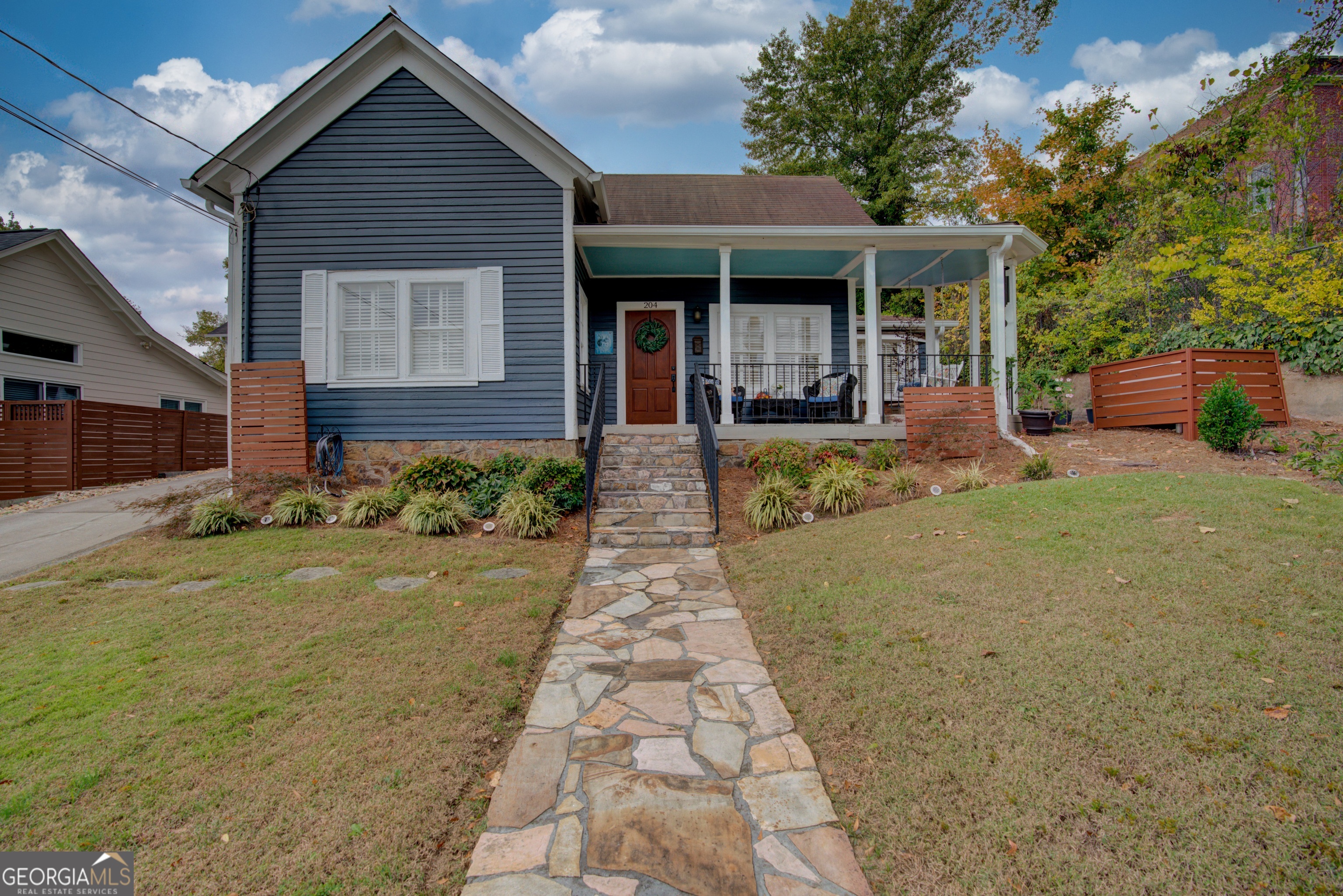 a front view of a house with garden