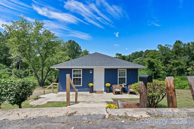 a view of a house with backyard sitting area and garden
