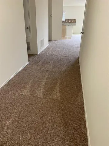 a view of a big room with closet and front door